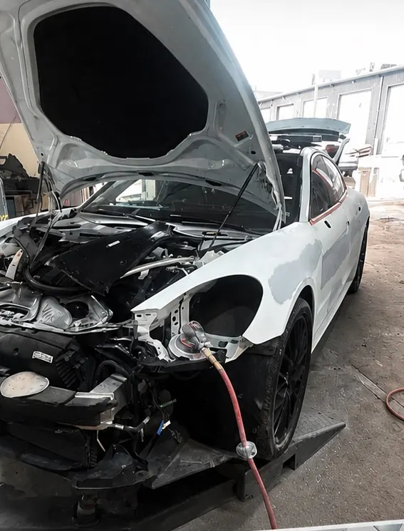 Porsche Panamera with the front end taken apart for repair in the RM shop