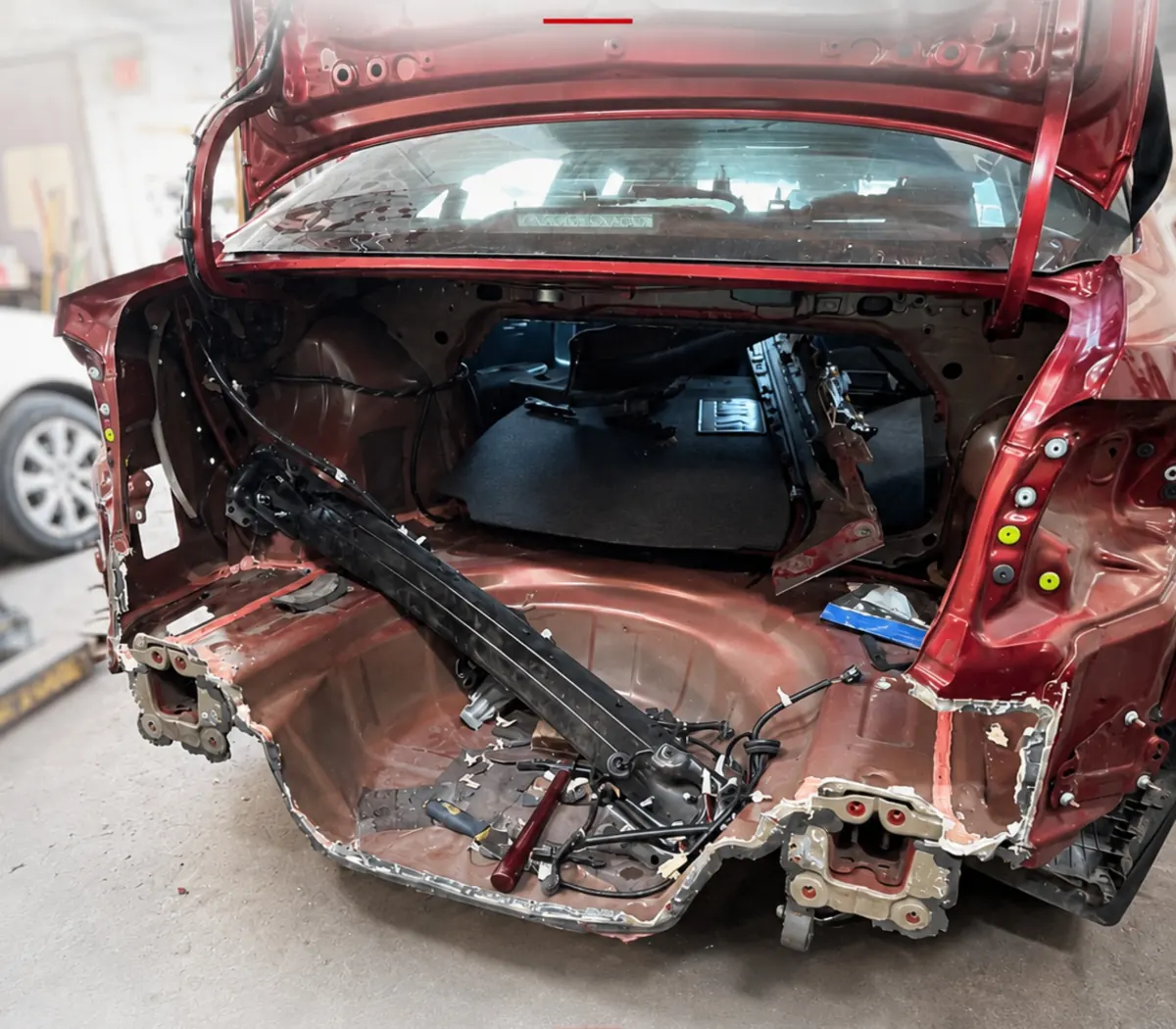 Red sedan with the rear body torn open
